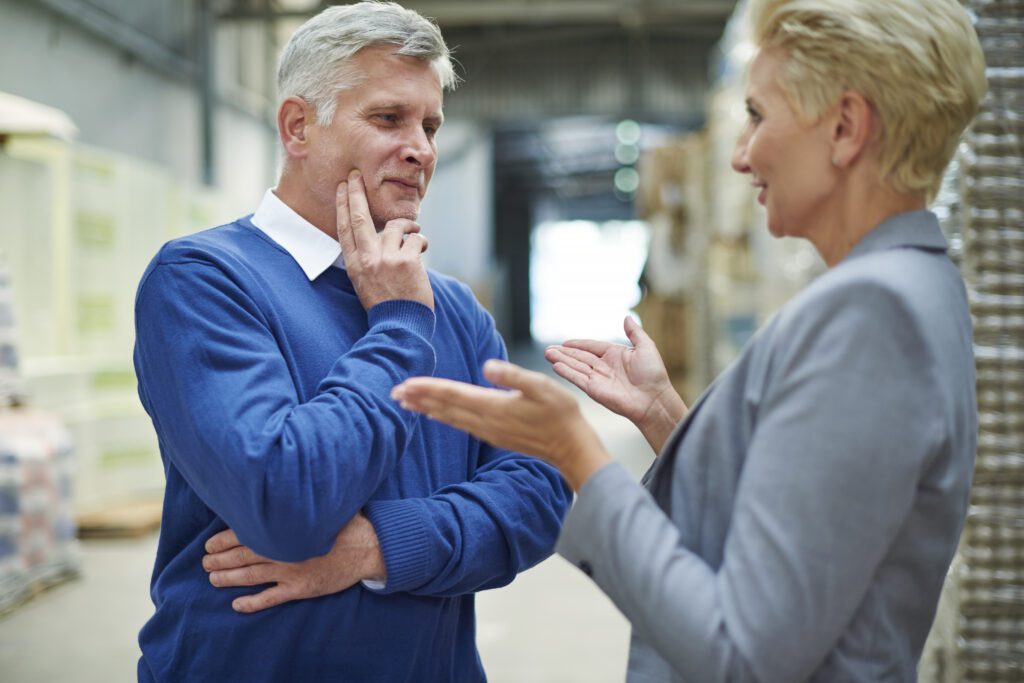 A blue shirt old man listening the lady with empathy and carefully