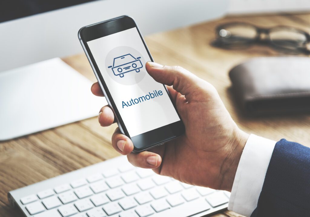 A man holding phone with a sign of automotive service on internet