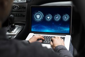 A man working on laptop for automotive reputation management
